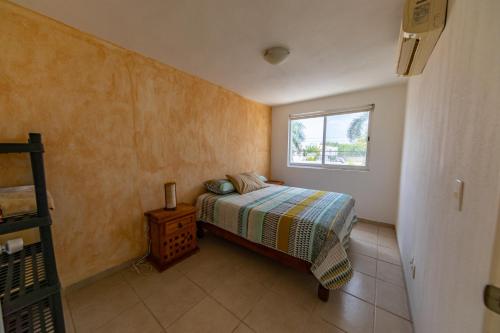 a small bedroom with a bed and a window at Casa LUNA in Mezcales