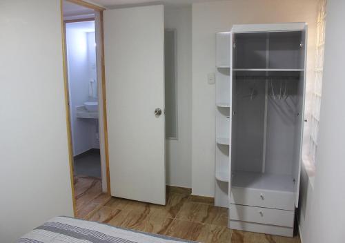 a room with a white closet with an open door at Acogedor departamento en el centro de Barranco in Lima