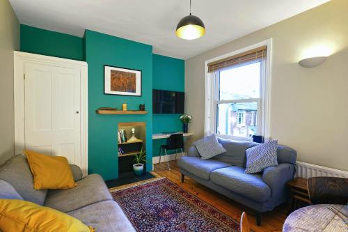 a living room with a couch and a chair at Calm 1 Bed Apartment with Parking in Winchester by At Hem in Winchester