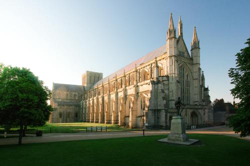a large building with a statue in front of it at Calm 1 Bed Apartment with Parking in Winchester by At Hem in Winchester