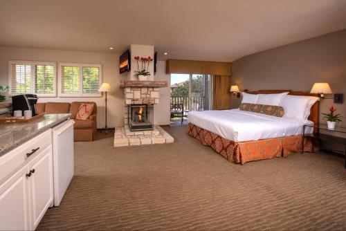 1 dormitorio grande con 1 cama y chimenea en Horizon Inn & Ocean View Lodge, en Carmel