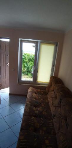 a bedroom with a bed and a large window at Apartamenty jezioro Białe in Okuninka