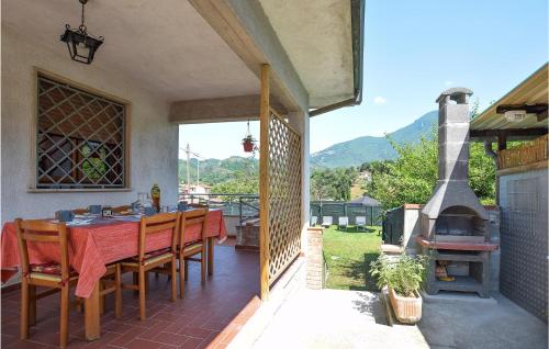 a patio with a table and chairs and a grill at Nice Home In Camaiore With Kitchen in Camaiore