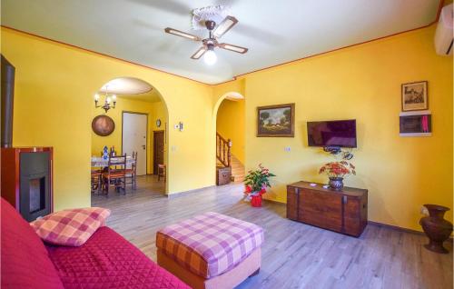a living room with a red couch and a tv at Nice Home In Camaiore With Kitchen in Camaiore