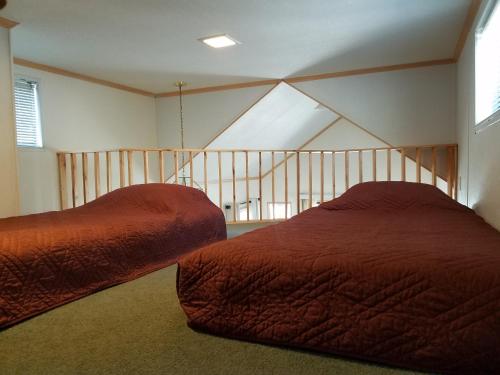 a bedroom with two beds and a skylight at Circle K Ranch in Rico