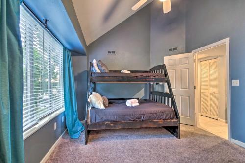 two bunk beds in a room with a window at Deck, Pool and Views Lake of the Ozarks Condo in Kaiser
