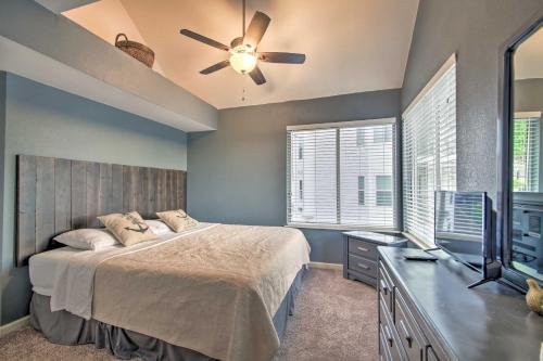 a bedroom with a bed and a ceiling fan at Deck, Pool and Views Lake of the Ozarks Condo in Kaiser