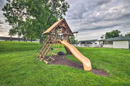 a playground with a slide in the grass at Deck, Pool and Views Lake of the Ozarks Condo in Kaiser