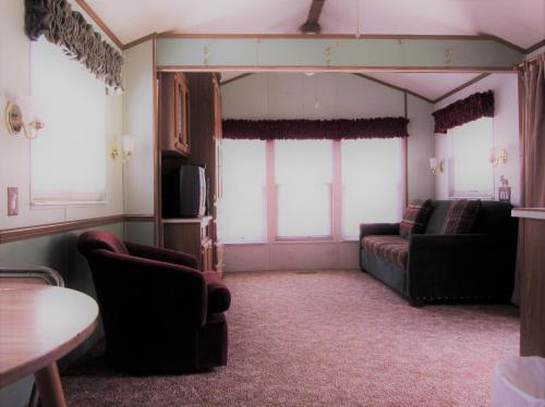 a living room with two couches and a tv at Circle K Ranch in Rico