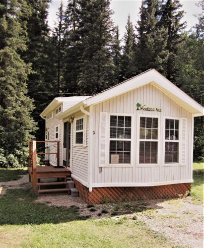 a white tiny house with a porch at Circle K Ranch in Rico