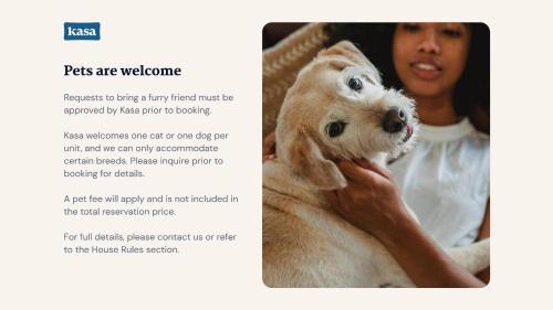 a woman holding a puppy in her hands at Kasa FreeMoreWest Charlotte in Charlotte