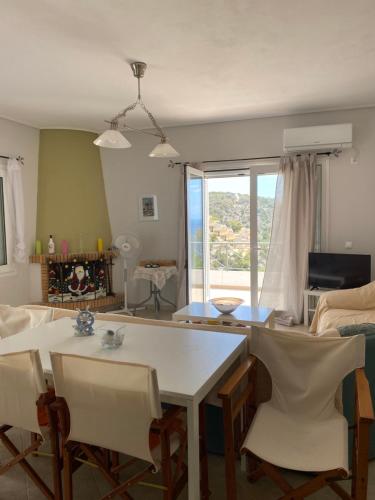 a living room with a white table and chairs at Mikro Amoni Beach Villa in Pefkali