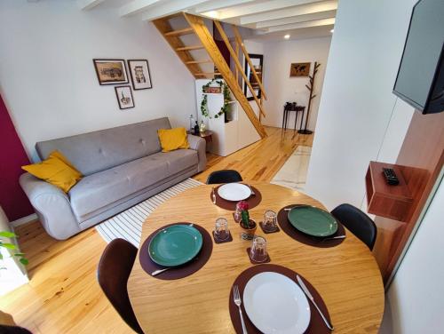 a living room with a wooden table and a couch at WLoft in Vila Nova de Gaia