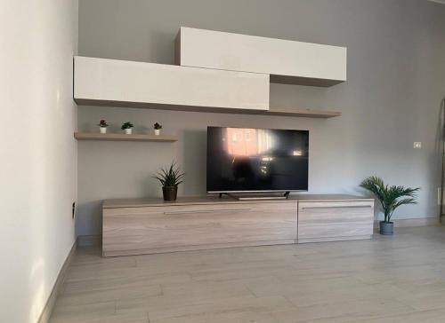 a living room with a flat screen tv on a entertainment center at Shining house in Milan in Milan
