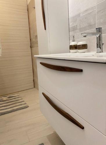 a bathroom with a white drawer with a microwave at Shining house in Milan in Milan