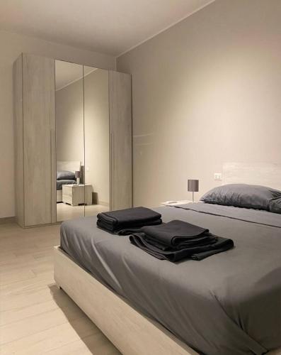 a bedroom with a large bed with a large mirror at Shining house in Milan in Milan