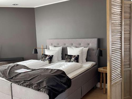 a bedroom with a large bed with two pillows at Best Western Hotel Herman Bang in Frederikshavn
