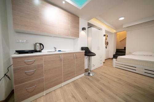 a kitchen with a sink and a bed in a room at Seven in Sarajevo