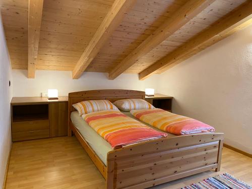 a bed with two pillows on it in a room at Loft Mountain Spirit in Livigno