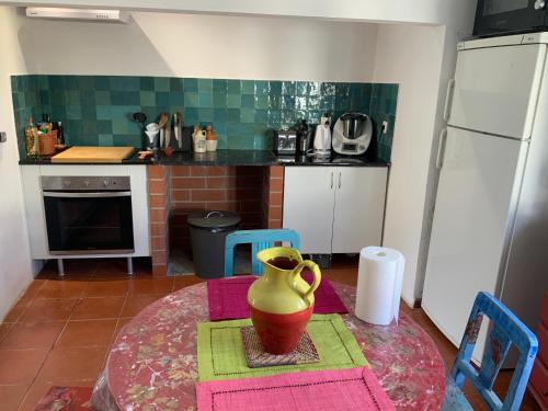 a kitchen with a table with a vase on it at Ilha ALFRIDA in Carrapatelo