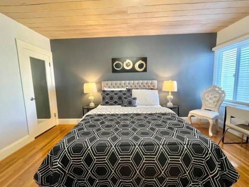 a bedroom with a black and white bed and a chair at Golden Gate Park Sweet Home- 3 Bedrooms in San Francisco