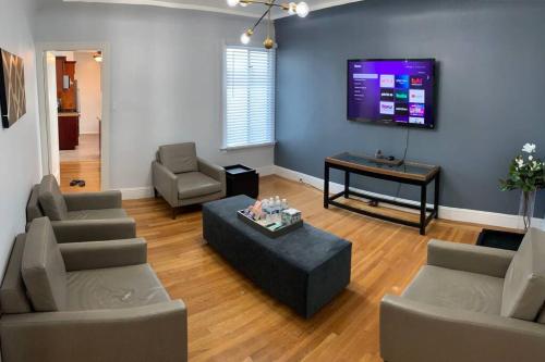 a living room with couches and a flat screen tv at Golden Gate Park Sweet Home- 3 Bedrooms in San Francisco