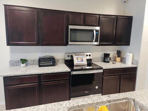 a kitchen with wooden cabinets and a microwave at Phoenix Comfort home II in Phoenix