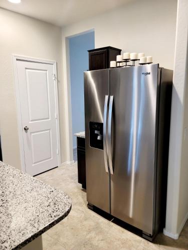 a kitchen with a stainless steel refrigerator in a room at Phoenix Comfort home II in Phoenix