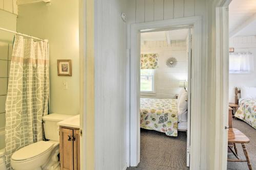 a bathroom with a toilet and a bedroom with a bed at Steps to Ocean Breezy Myrtle Beach Bungalow! in Myrtle Beach