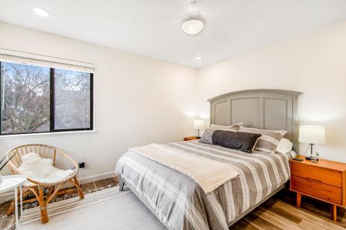 a bedroom with a bed and a desk and a window at Admirals Cove in Coupeville