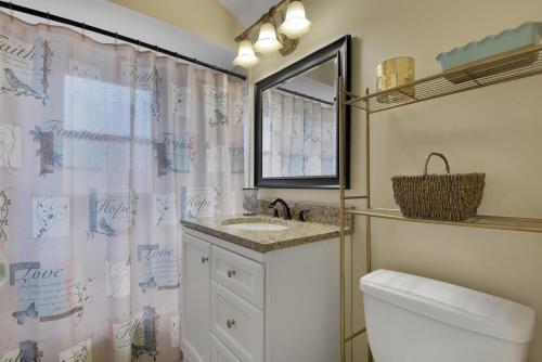 a bathroom with a sink and a toilet and a mirror at 5 Star Monthly Cozy Entire Home in Melrose Park