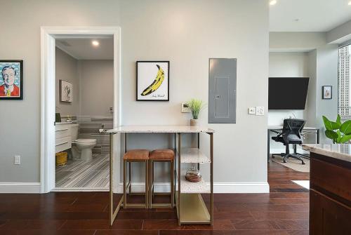 a kitchen with a table and stools in a room at HostWise Stays - Free Parking Downtown - Skyline Views in Pittsburgh