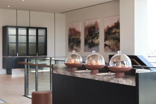 four bowls of food on a counter in a room at Hyatt Place Melbourne Caribbean Park in Scoresby