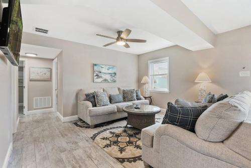 a living room with two couches and a ceiling fan at Spectacular 3 BR Condo One Block to the Beach in Brigantine