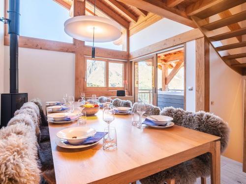 une salle à manger avec une table et des chaises en bois dans l'établissement Chalet Landenoire · Ski-in/Ski-out · Sauna & Jacuzzi · Parking · WiFi · 8 Pers. - FR-1-344-777, à Saint-Martin-de-Belleville