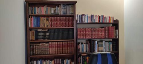 a book shelf filled with lots of books at Casa Ramirez - Guest House in Sucre