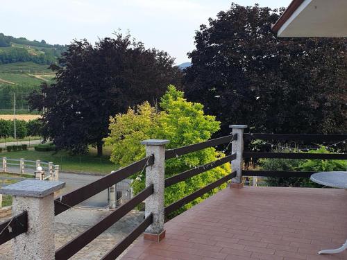 a wooden fence with a table on top of it at Vesime Villa with Garden in Vesime
