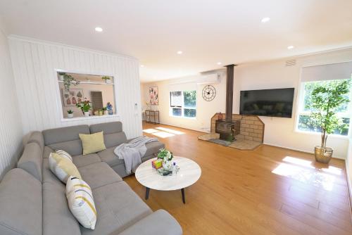 a living room with a couch and a table at Best Location Entire House Staycation Parkland Surrounding in Hallam