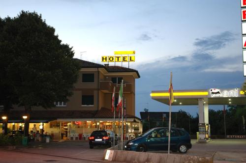 a hotel with cars parked in front of a gas station at Hotel Da Angela in Sedegliano