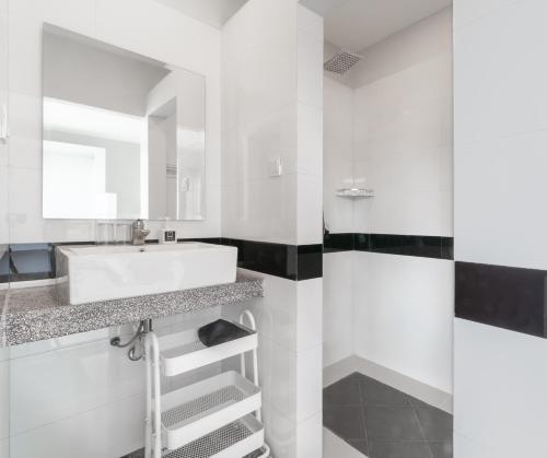 a bathroom with a sink and a mirror at La Bastide de Caro in Siem Reap