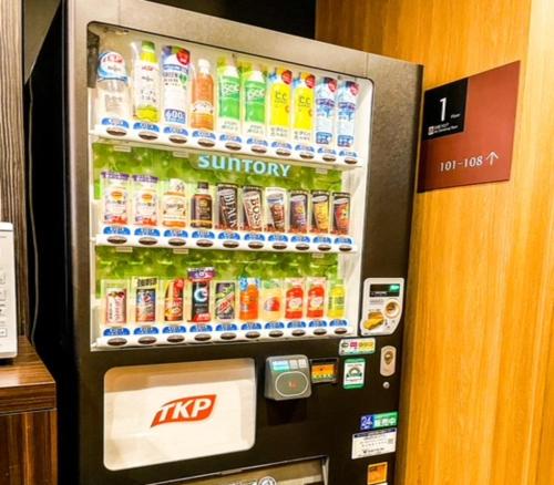 a vending machine filled with bottles of soda at APA Hotel TKP Tokyo Nishi-Kasai in Tokyo