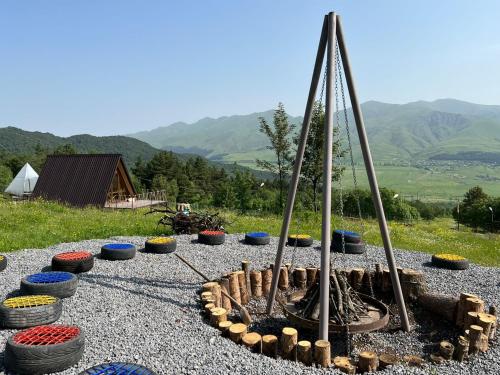 a fire pit on a gravel ground with many pots at GLAMPING WOLF MOUNt in Margahovit