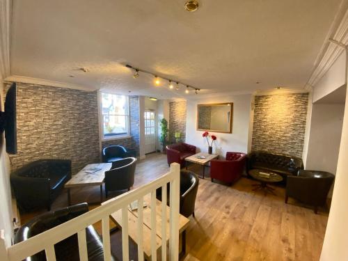 a living room with chairs and a table and a room at The County Hotel - Self Check-In, Ultra Fast WI-FI, Free Parking, Central Location in Selkirk