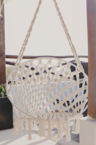 a white rattan basket on a table at Hotel Sun Ha Bacalar in Bacalar