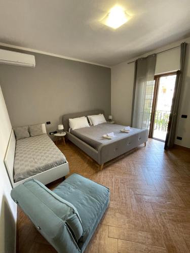 a bedroom with two beds and a couch at Lamezia Park Apartments in Lamezia Terme