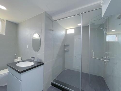 a bathroom with a sink and a glass shower at Căn Hộ 4 Phòng Ngủ View Biển - Sông Mường Thanh Luxury Khánh Hòa Cầu Trần Phú in Nha Trang