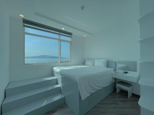 Giường trong phòng chung tại Căn Hộ 4 Phòng Ngủ View Biển - Sông Mường Thanh Luxury Khánh Hòa Cầu Trần Phú