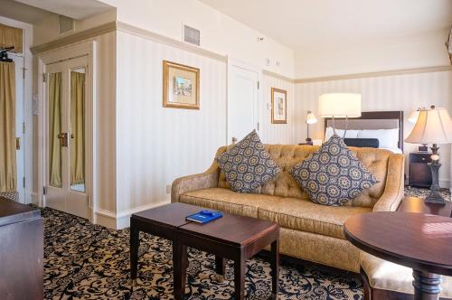 a living room with a couch and a table at Gaslamp Plaza Suites in San Diego