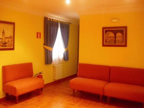 a waiting room with two chairs and a window at Hostal La Mancha in Tarazona de la Mancha