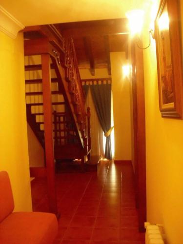 a hallway with a staircase in a house at Hostal La Mancha in Tarazona de la Mancha